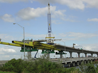 In areas with limited access, concrete segments were delivered over the completed portions of the elevated roadway. Maintaining traffic during construction is a benefit important to the future of expanding our national transportation corridors.