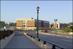 Photo of the approach into the ne Phalen Boulevard from the west over the first bridge structure. The corridor includes decorative street lights and aesthetic bridge railing. The roadway leads into an area with new business park developments.