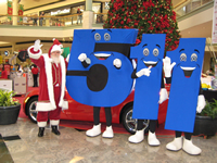 Mascots representing the 5-1-1 travel information number, with Santa Claus, on location at Gwinnett Place Mall.