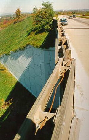 Photo showing noise barrier attachment/reinforcement details on a bridge structure