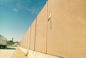 Photo of a noise barrier with airborne debris damage