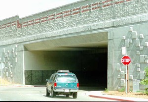 Photo of a concrete noise barrier on a bridge from the resident's side