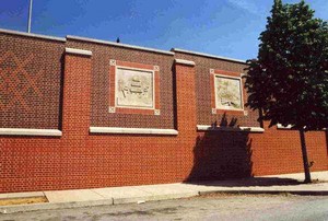 Photo of concrete inserts, also called icon panels, in a brick noise barrier