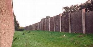 Photo of overlapping noise barriers to maintain drainage