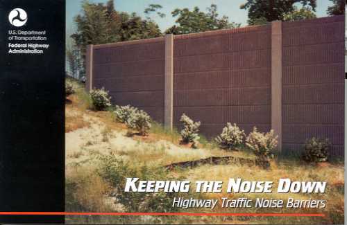 photo:  precast concrete noise barrier, with concrete posts and vegetation planted on the highway side of the barrier (photo is intended to emphasize the subject of noise barriers)
