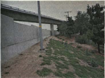 Shrubs or vines next to the wall would help to reduce the barren look here.