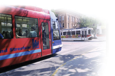 photo of two busses at an intersection