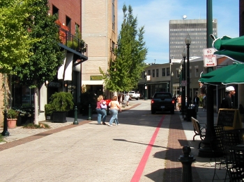 A photo of a pedestrians and motorists along a pedestrian friendly street in Asheville, NC.