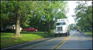 A heavy truck uses side streets en-route to a construction project in a suburban area. 