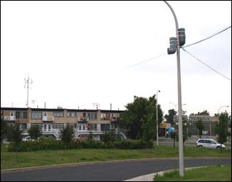 Experimental sound system of two speakers and amplifiers mounted on a light pole is used to mask nighttime construction noise for a nearby apartment community.