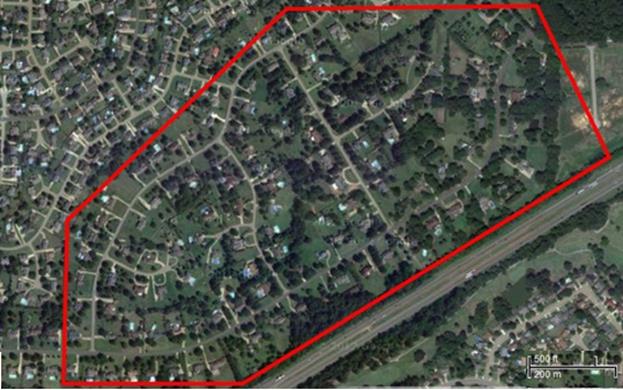 Study Area D: Eight-lane highway with low-density houses set back from the highway. The figure represents a proposed widening to an eight-lane highway facility. The road is on a slight fill and there are several rows of relatively closely spaced houses, with the closest houses nearly 300 feet from the road, yet still being impacted by the proposed project. 