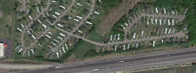 Aerial phot showing community for which a noise barrier was proposed by TDOT, Project TDOT-1. It shows mobile homes, that are rented. The barrier was determined to be reasonable due to 79% of residents voted for the barrier. The highway is in the lower portion of the photo, with the mobile homes above it. 
