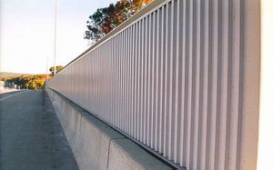 Photo of a metal noise barrier with a vertical surface texture