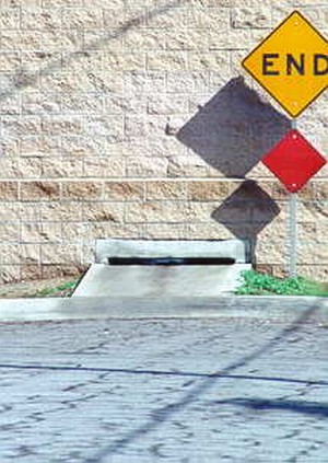 Photo of a noise barrier with a drainage structure underneath the barrier