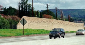 Photo of a noise barrier with a surface treatment outlining mountains