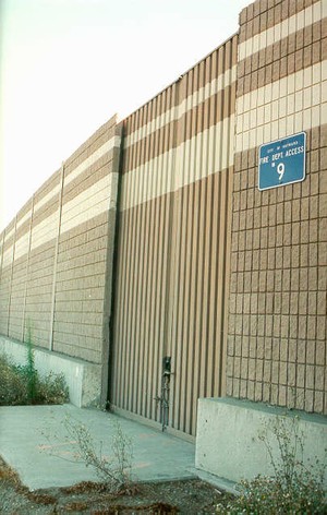 Photo of a noise barrier panel with an emergency access opening