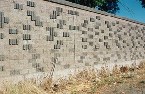 Photo showing a pattern on the noise barrier surface of varying textured and colored blocks