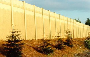 Photo of a concrete noise barrier with coating