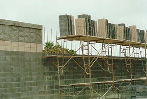 Photo of a masonry block noise barrier under construction