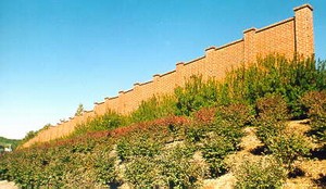 Photo of concrete pre-cast noise barrier with brick texture and brick color