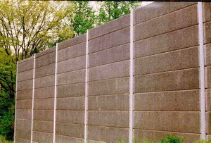 Photo of a pre-cast concrete noise barrier with absorptive rubber surface treatment