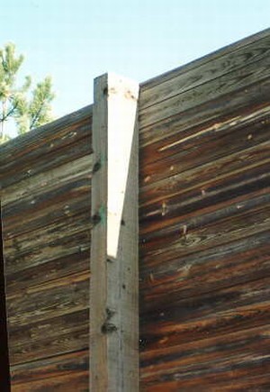 Photo of a wooden noise barrier with rectangular wooden posts