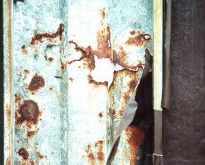 Photo showing deterioration of a metal panel due to moisture