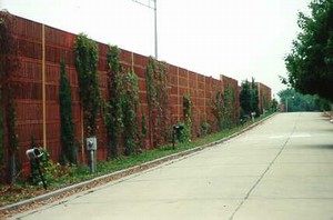 Photo of a wooden noise barrier that is naturally weathered