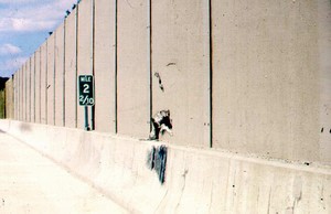 Photo of a noise barrier with vehicle impact damage