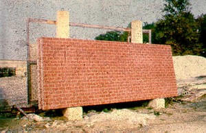 Photo showing a pre-cast concrete noise barrier pan with a stamped brick surface treatment