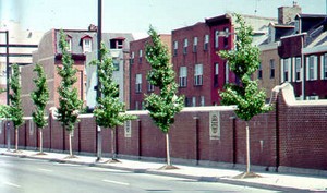 Photo of a noise barrier with a brick surface finish