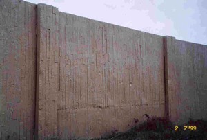 Photo of a concrete noise barrier with the panel ends designed to conceal the joints between panel and post