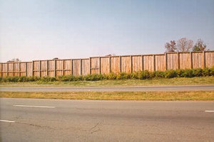 Photo of a wooden noise barrier with vertical planks