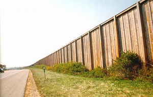 Photo of a glue laminated post and plank noise barrier