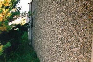 Photo of a noise barrier with exposed aggregate concrete surface texture