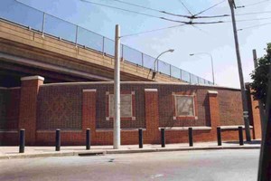 Photo of concrete inserts, also called icon panels, in a brick noise barrier