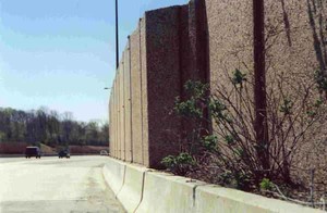 Photo of a noise barrier protected by a concrete safety barrier