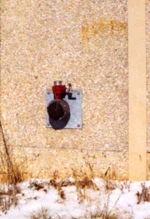 Photo of a noise barrier with a firehose access opening
