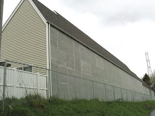 A chain link fence along back of townhomes