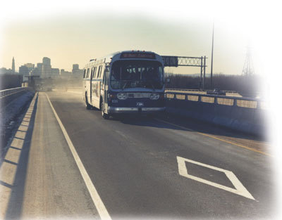 Photo of a bus on an HOV lane marked with a diamond
