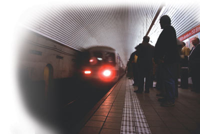 Photo of people on a subway platform and approaching train.