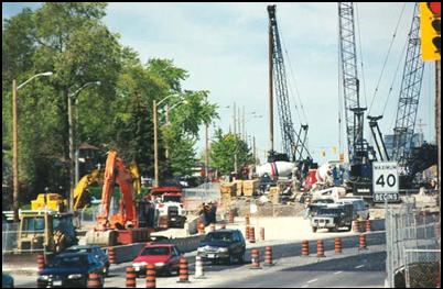 A highway re-alignment project near an existing highway where multiple construction activities are occurring simultaneously; due to the multitude of equipment, such as cranes, front end loaders, dump and cement mixing trucks, noise levels may be high and the entire operation could be measured 