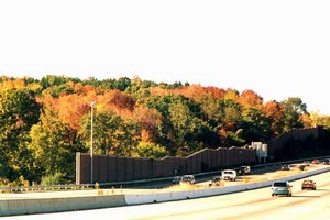 Photo of a noise barrier where the top of the wall mimics the local hilly topography 