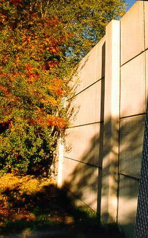 Photo showing noise barrier end treatment into vegetation