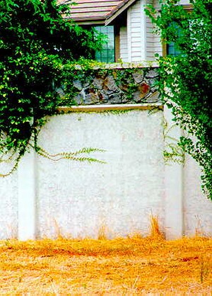 Photo of a noise barrier with a stucco like surface pattern