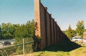 Photo of a noise barrier with a brick surface finish