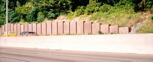 Photo showing noise barrier end treatment burying the end of the barrier into the ground