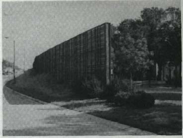 Plantings will eventually help to hide these walls and reduce visual awareness of the walls.