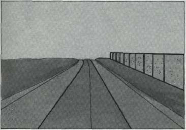 A long, high wall on one side of a highway axis creates a distracting visual imbalance. The eye is drawn to the wall and away from the road ahead.