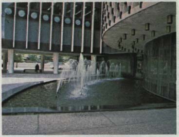 photo of an office building plaza with a water fountain